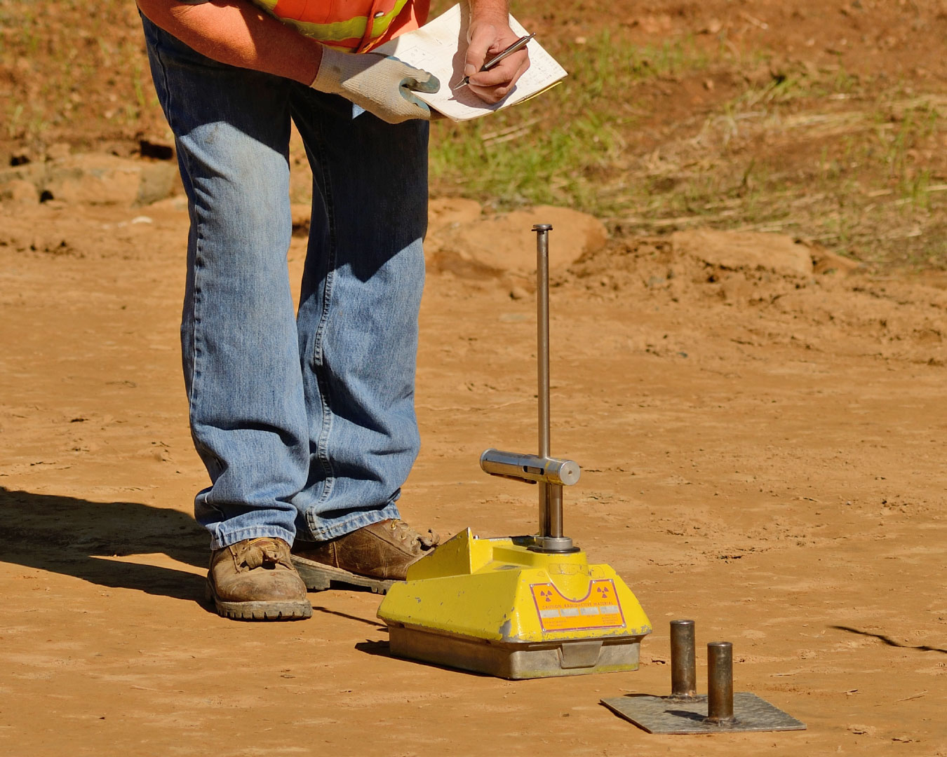 Engineer using a Nuclear Density Gauge to check for soil density of a soil lift