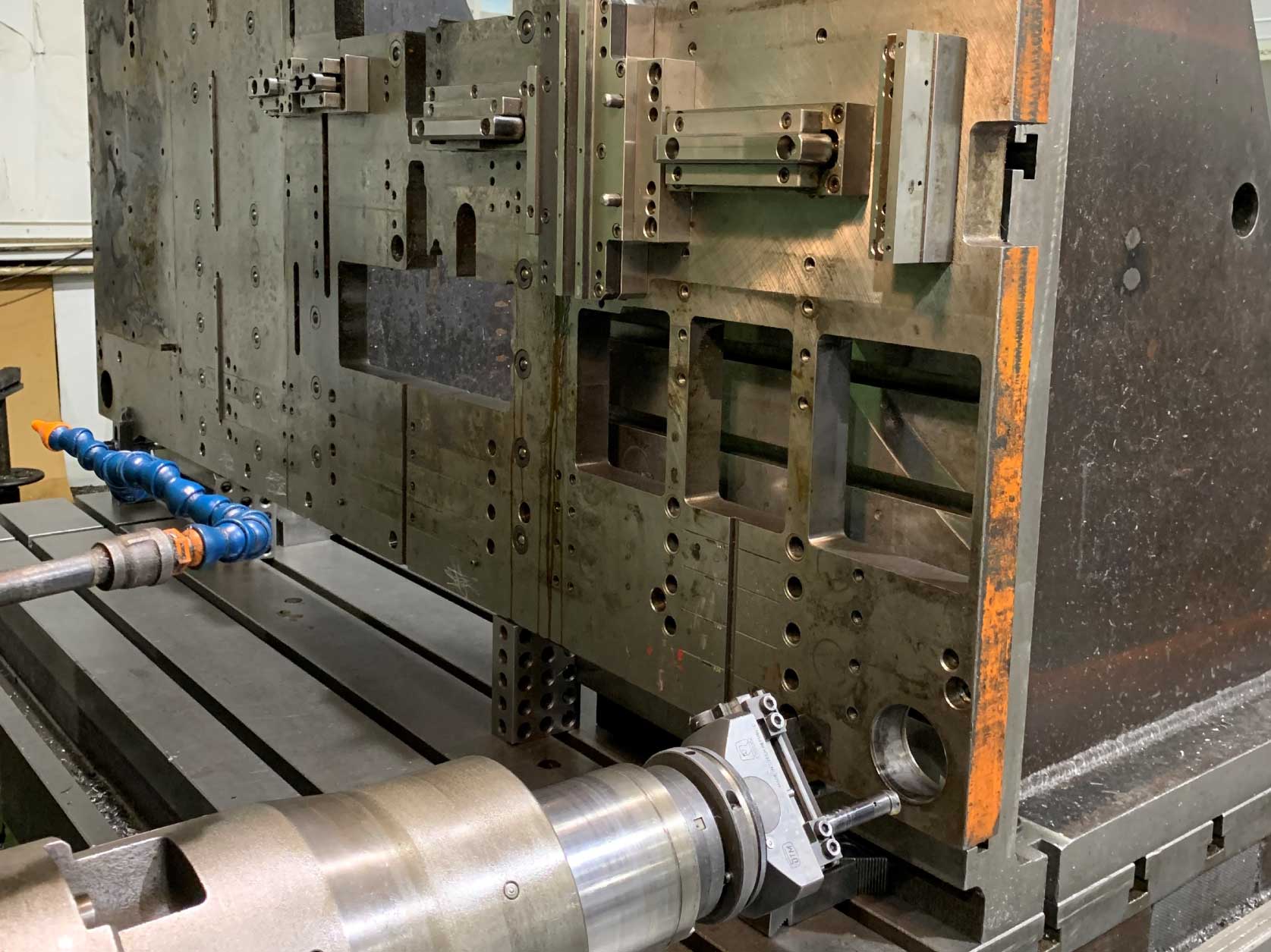 Preparing to repair a worn hole guide pin hole in a 4-ft wide by 8-ft long by 2-inches thick progress die set piece that weighs about 3,000 pounds.