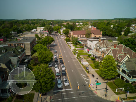 Aerial drone view of cars driving in American neighborhood of Main Street in Stroudsburg, Pennsylvania.
