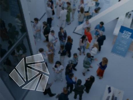 Blurred overhead crowd shot – professionals connecting at event with UTRS icon logo