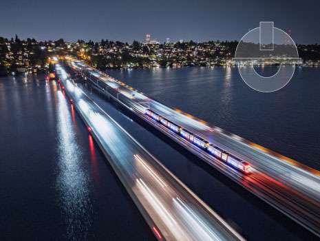 The world’s first light rail system crossing a floating bridge over Lake Washington in Seattle, WA at night.